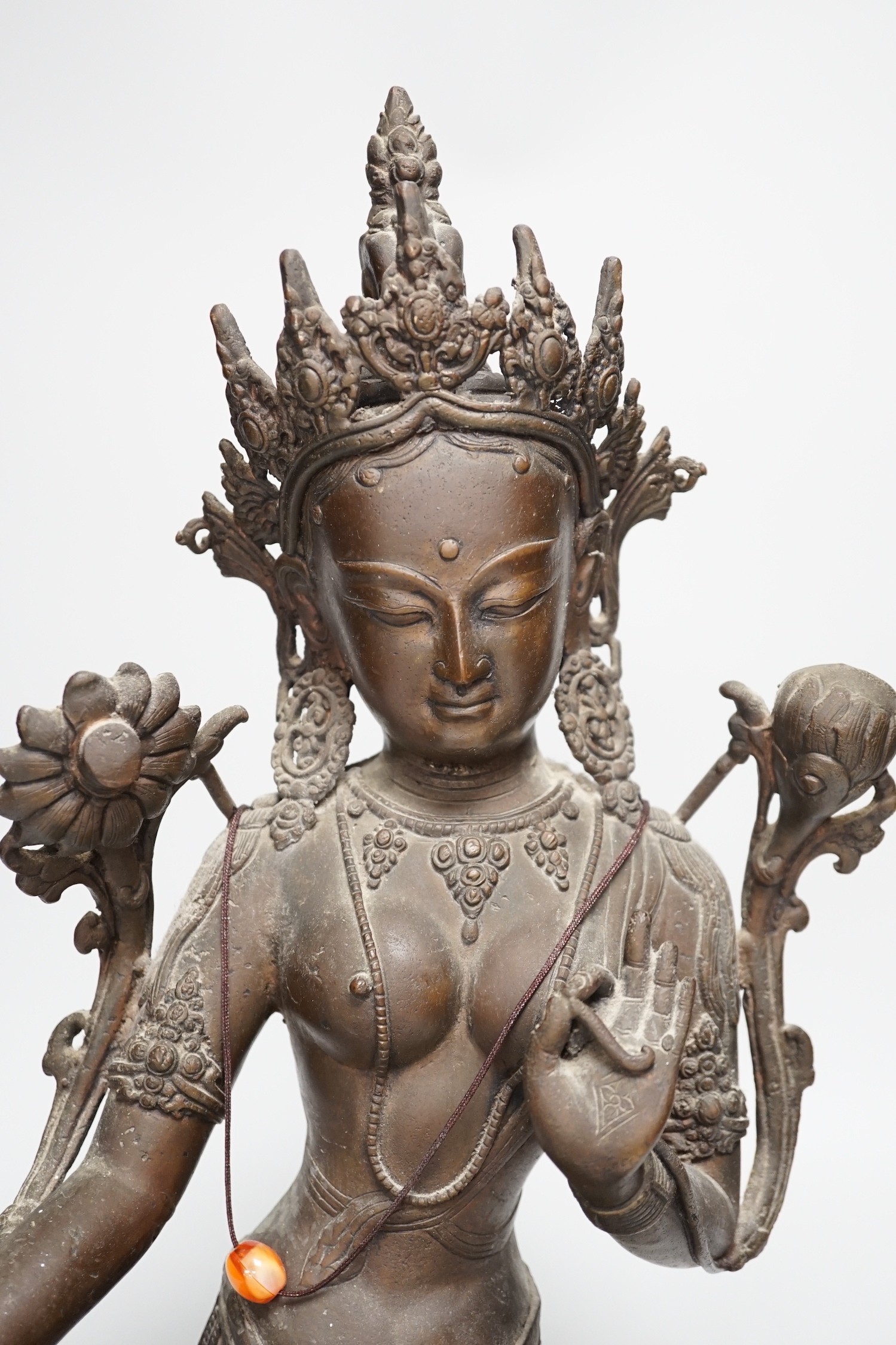 A Buddhist bronze seated figure of Green Tara. 42cm tall